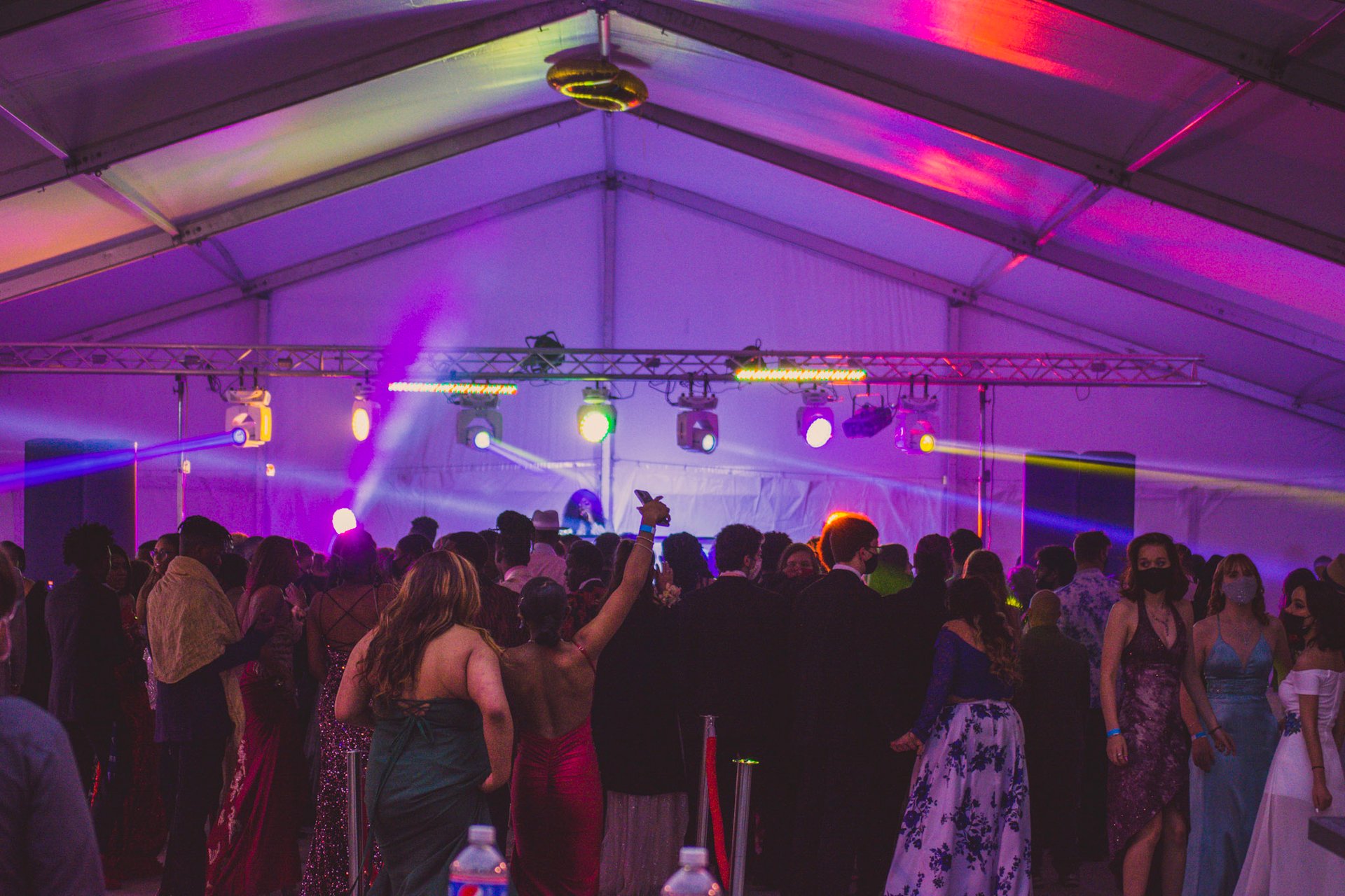 High-energy tent party with stage lighting